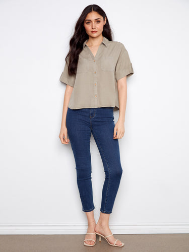 This stylish top includes short sleeves with button tabs, adding a touch of functionality and flair. By Charlie B.