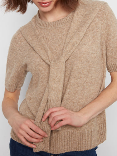 This stylish beige top has short sleeves and an attached sweater detail, adding flair to any outfit by Charlie B.