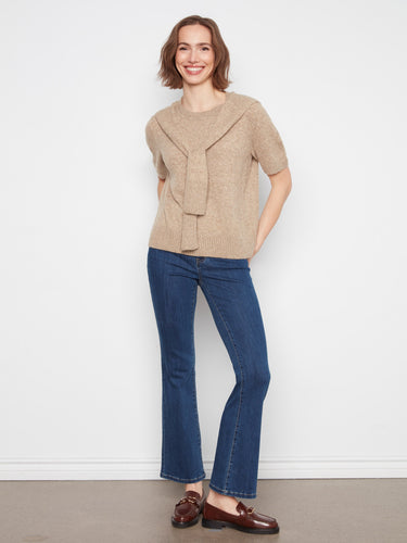 Crafted from soft knit fabric, this beige sweater offers both warmth and elegance for any occasion by Charlie B.