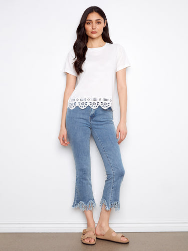 Elegant white short sleeve top featuring detailed bottom hem embroidery, crafted from pure cotton by Charlie B.