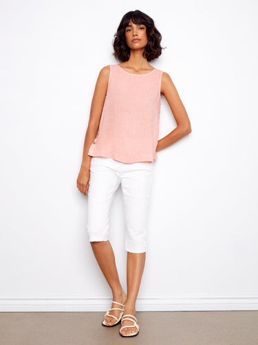 Elegantly designed with a high-low hem, this sleeveless top offers both style and comfort in a subtle pink hue by Charlie B.