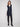 Black sleeveless vest with mid-thigh length, featuring a zip front and patch pockets by Charlie B.