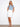 White skort with a regular rise and frayed hem, featuring five pockets and button closure by Charlie B.