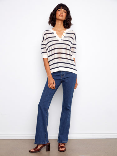 Showcasing an elegant fishnet crochet design, this striped top is ideal for layering in any season. By Charlie B.