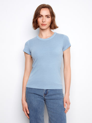 Blue semi-fitted top with ribbed texture, offering a chic and modern look. Perfect for casual outings or layering. By Charlie B.