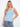 Light blue tank top with a scoop neckline, paired with jeans. The ribbed texture adds a stylish touch to the outfit by Charlie B.