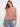 Chic sleeveless top with a scallop hem, paired with jeans for a relaxed look. Perfect for casual outings by Charlie B.