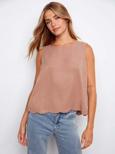 Chic sleeveless top with a scallop hem, paired with jeans for a relaxed look. Perfect for casual outings by Charlie B.