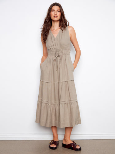 Elegant dress featuring a V-neckline and sleeveless design, perfect for warm weather. By Charlie B.