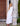 harlie B white sleeveless maxi dress with ruffle hem showing the midi vs maxi dress difference, styled with tan sandals.