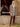 Unlined long crochet coat in sepia showcases an intricate geometric pattern and button closure for added elegance by Charlie B.