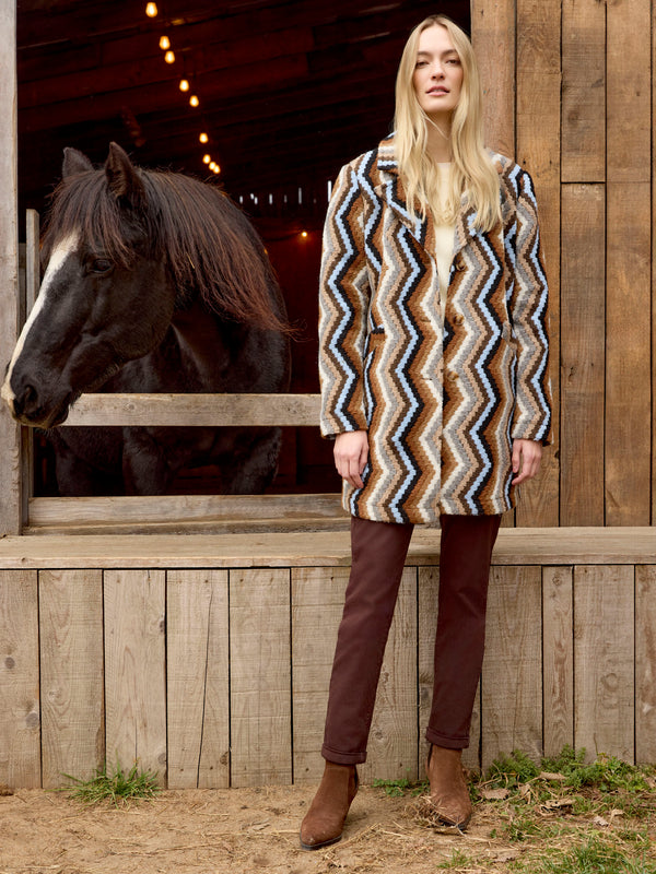Unlined long crochet coat in sepia showcases an intricate geometric pattern and button closure for added elegance by Charlie B.