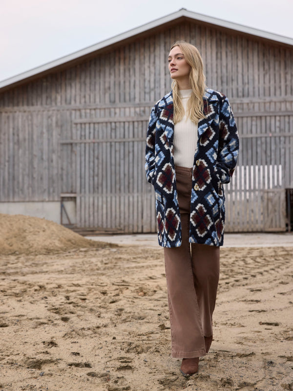 Elegant crochet coat featuring a tailored collar and intricate geometric designs in twilight hues by Charlie B.