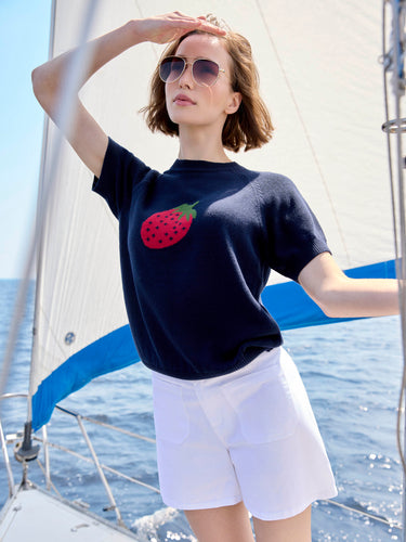 Trendy navy top showcasing placed jacquard detailing of a red strawberry, made from breathable 100% cotton material. By Charlie B.