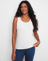 This white tank top features a scoop neckline, offering a classic and versatile look for any wardrobe. By Charlie B.