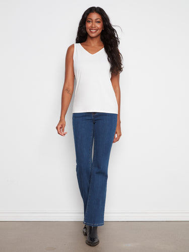 A sleeveless design ensures comfort and ease, perfect for layering or wearing alone. By Charlie B.