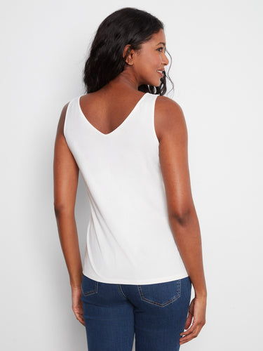 Enjoy the versatility of a reversible design in this chic white tank top. By Charlie B.