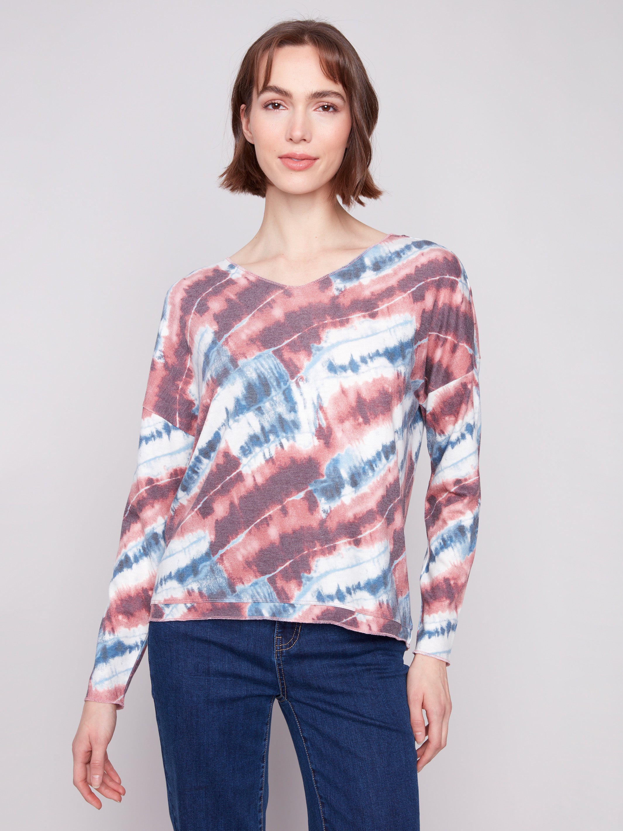 Pink tie-dye knit top featuring a relaxed fit with a V-neck design, perfect for casual wear by Charlie B.
