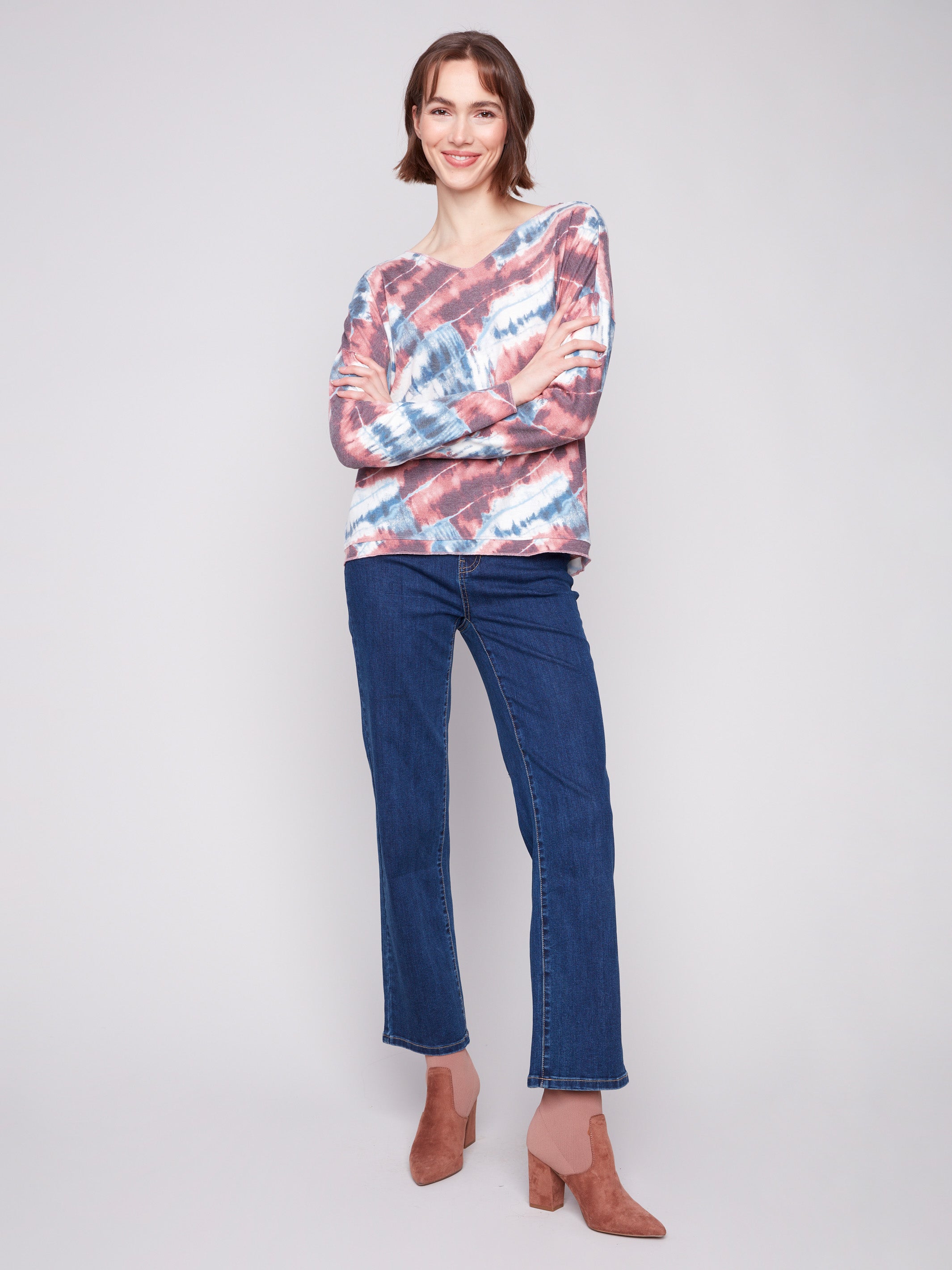 Trendy V-neck pink knit top with long sleeves and vibrant tie-dye design, great for layering by Charlie B.