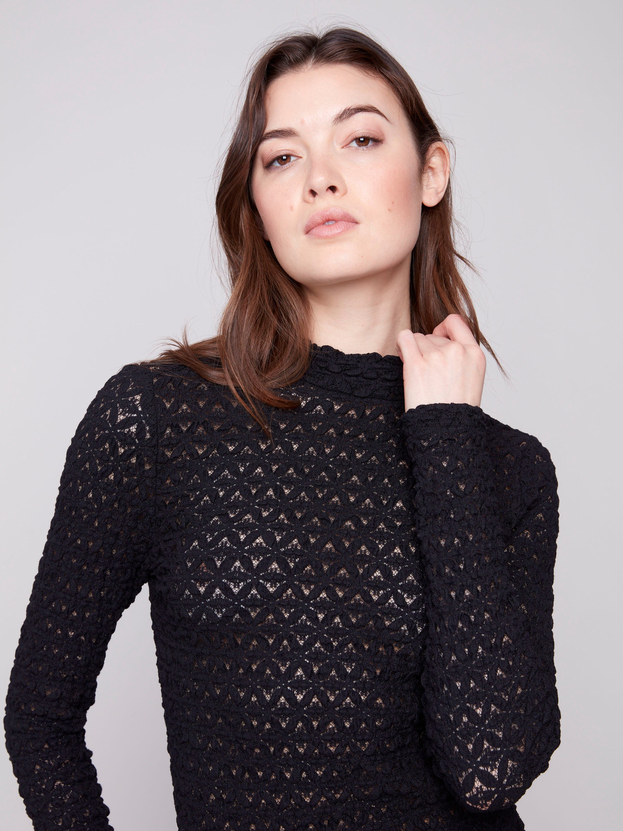 Stylish black lace blouse showcasing intricate patterns and a modern fitted style by Charlie B.
