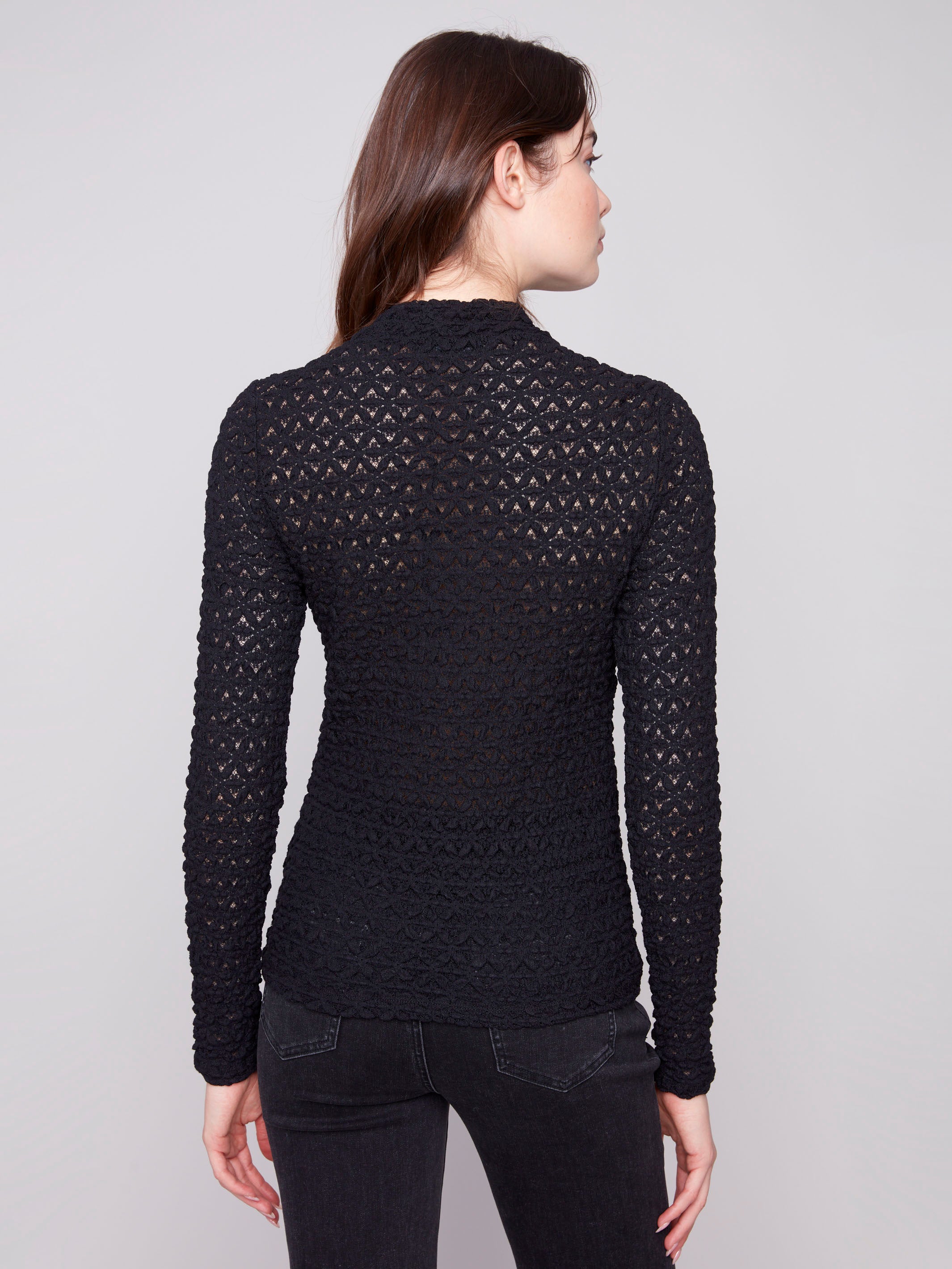 Sophisticated black lace garment with detailed patterning and semi-sheer elegance by Charlie B.