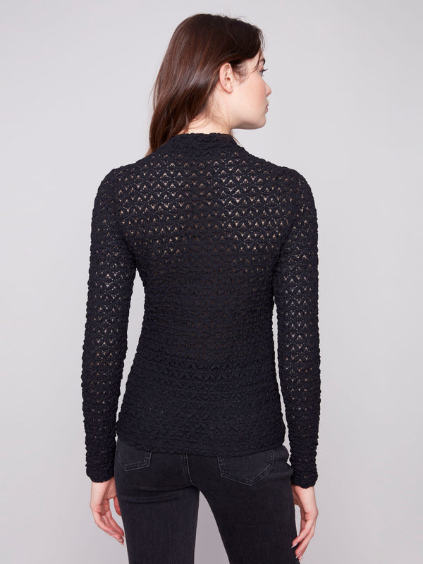Sophisticated black lace garment with detailed patterning and semi-sheer elegance by Charlie B.