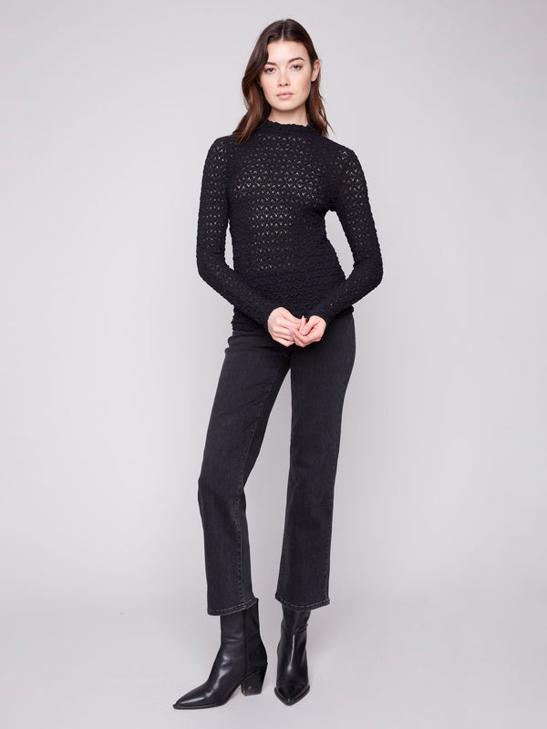 Fashionable black top with an intricate lace design offering a chic, fitted look by Charlie B.
