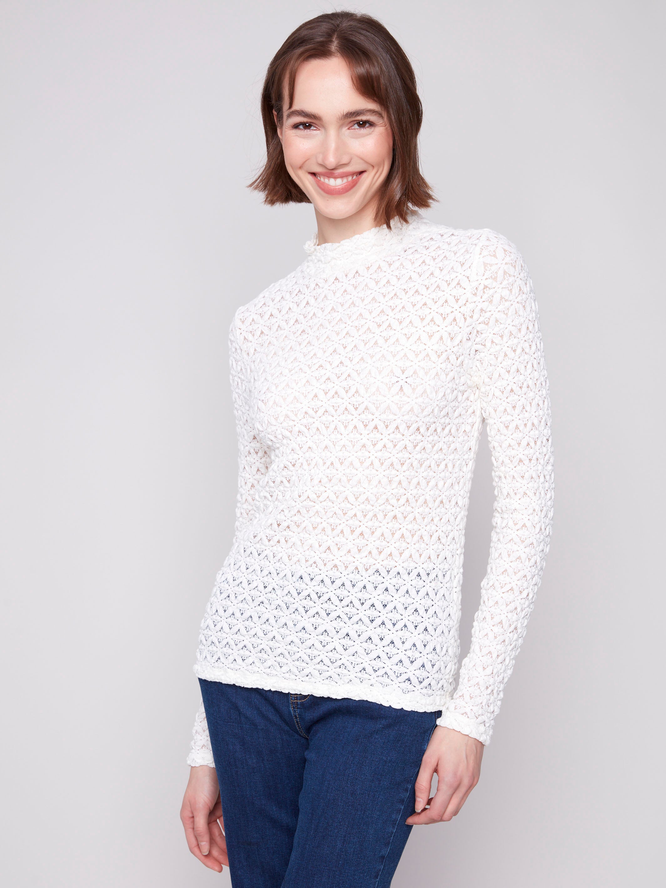 Intricate lace pattern on this ecru top offers both style and sophistication by Charlie B.