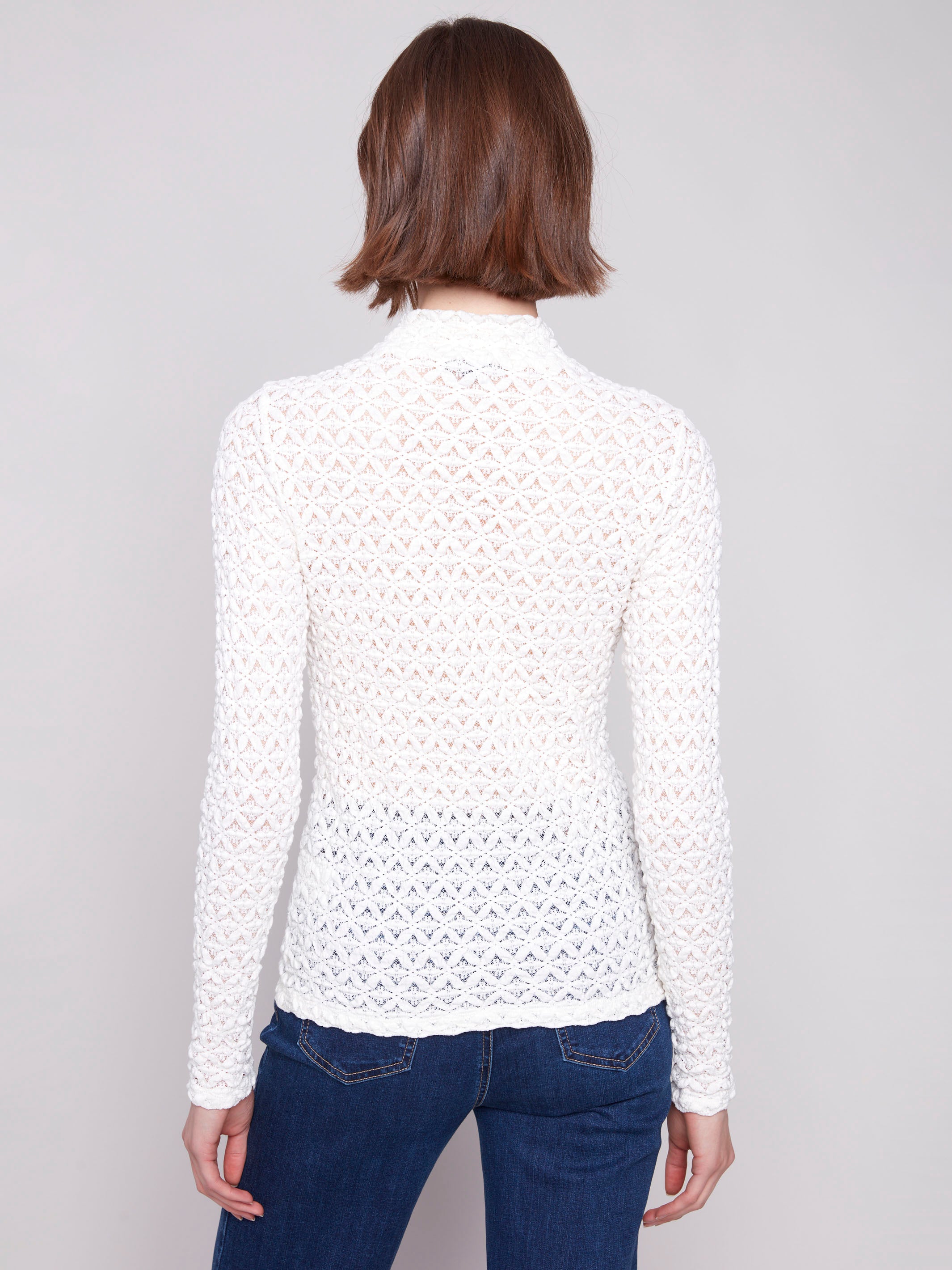 Ecru lace top showcasing a mock neck and detailed craftsmanship for an elegant look by Charlie B.