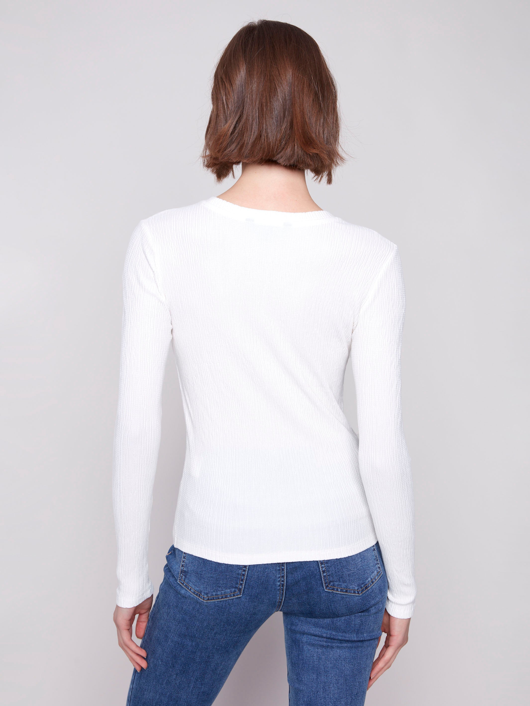 Ecru long sleeve textured knit top with a front knot by Charlie B.