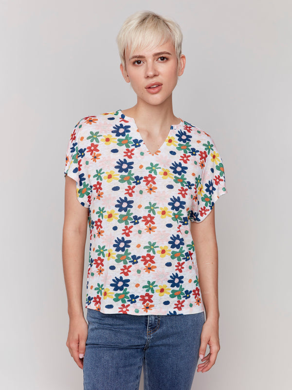 Stylish dolman sleeve top showcasing an elegant floral design by Charlie B.