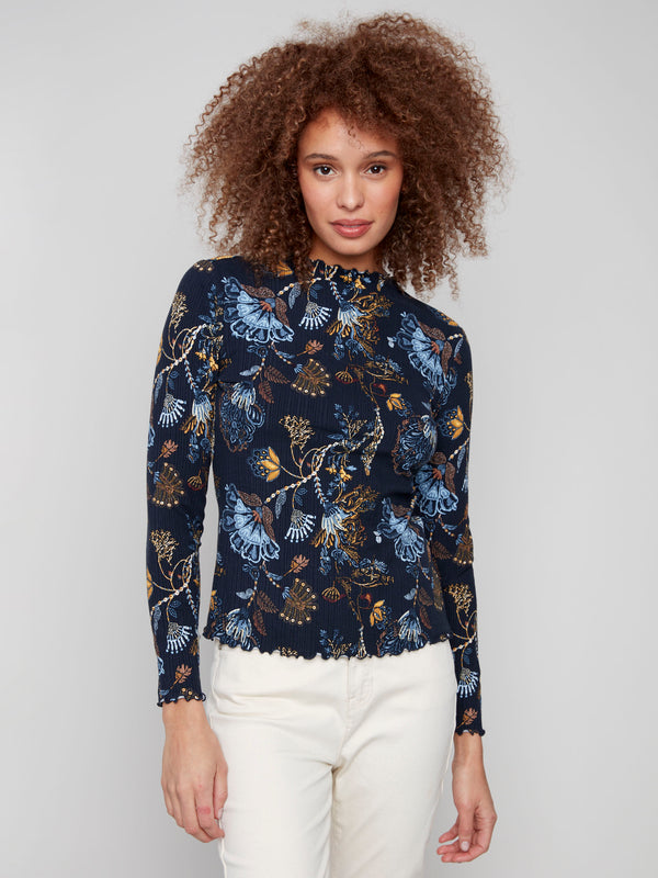 Floral patterned top with a mock neck and slim fit, featuring exquisite ruffle detail at the hem by Charlie B.
