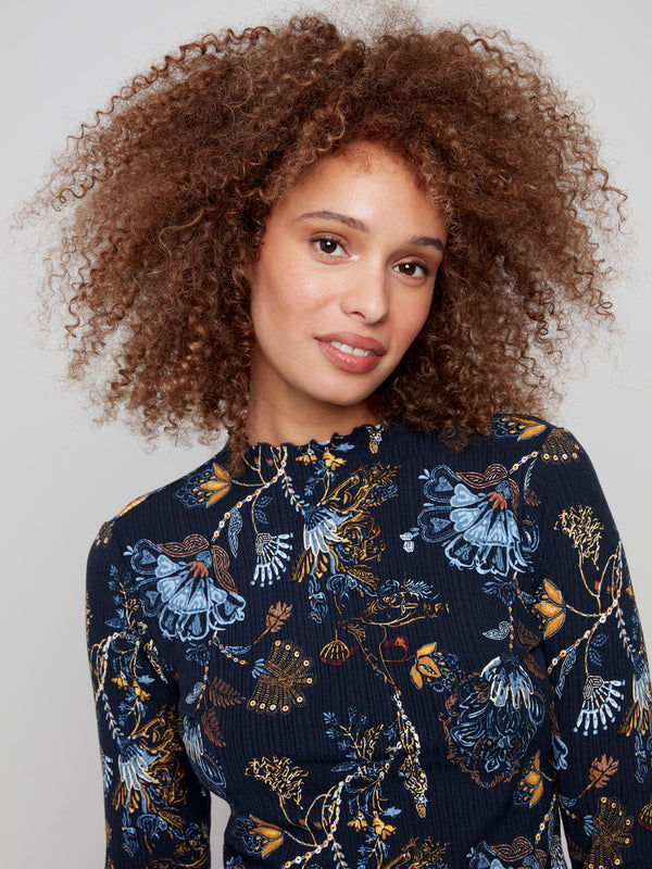 Chic mock neck top in a floral print, adorned with delicate ruffles that enhance its sophisticated style by Charlie B.