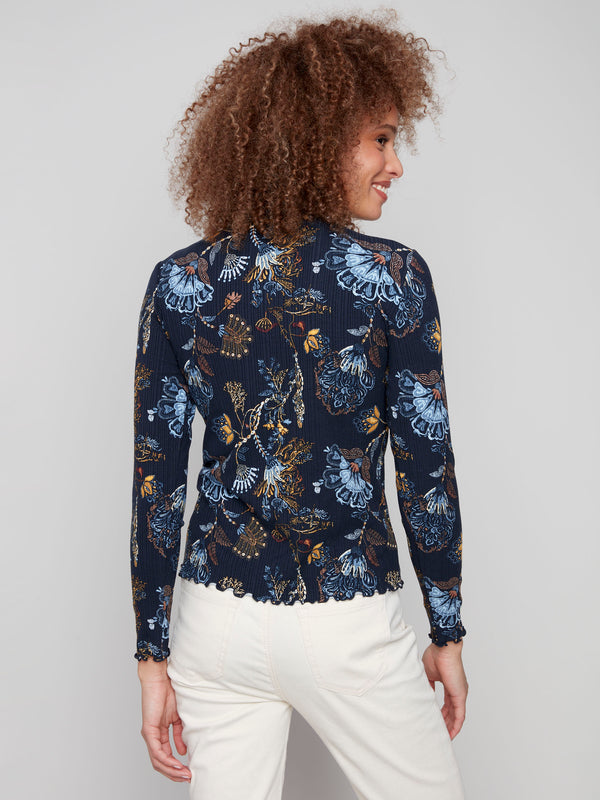 Stylish slim fit top featuring intricate floral patterns and charming ruffle details at the neckline by Charlie B.