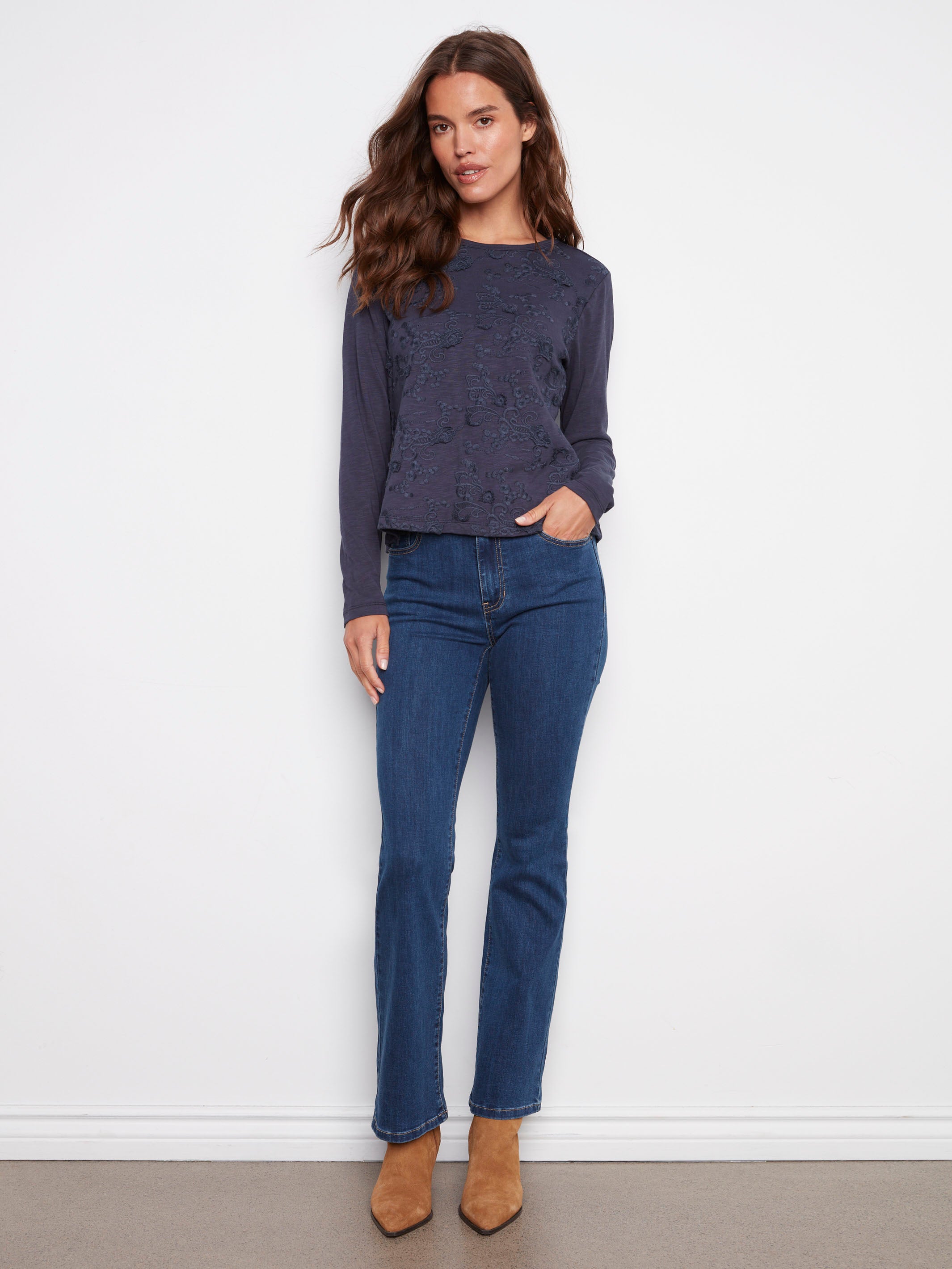 Elegant long-sleeve design with intricate floral embroidery on soft cotton fabric by Charlie B.