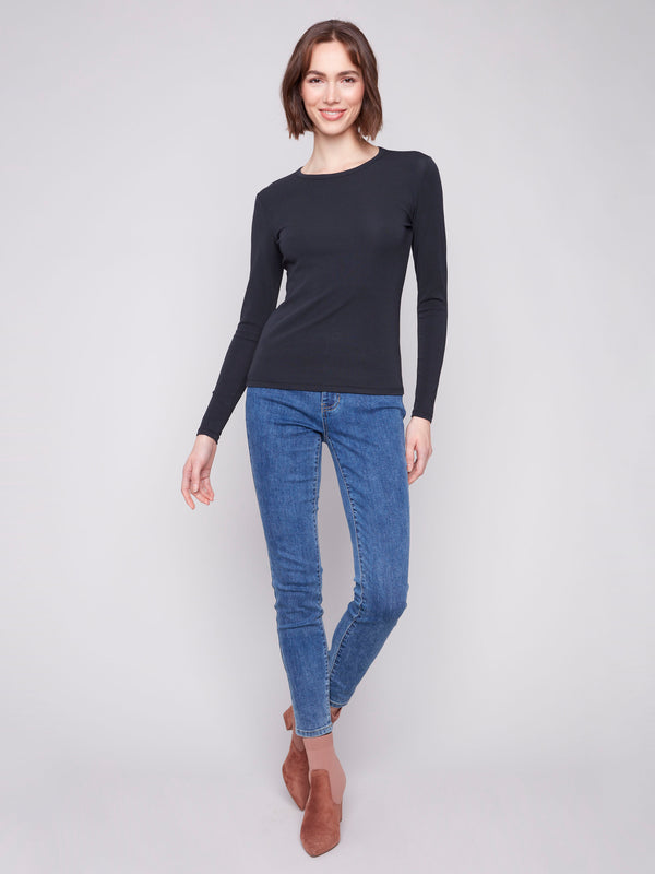 Sleek black knit top with long sleeves and a classic crew neckline, ideal for layering by Charlie B.