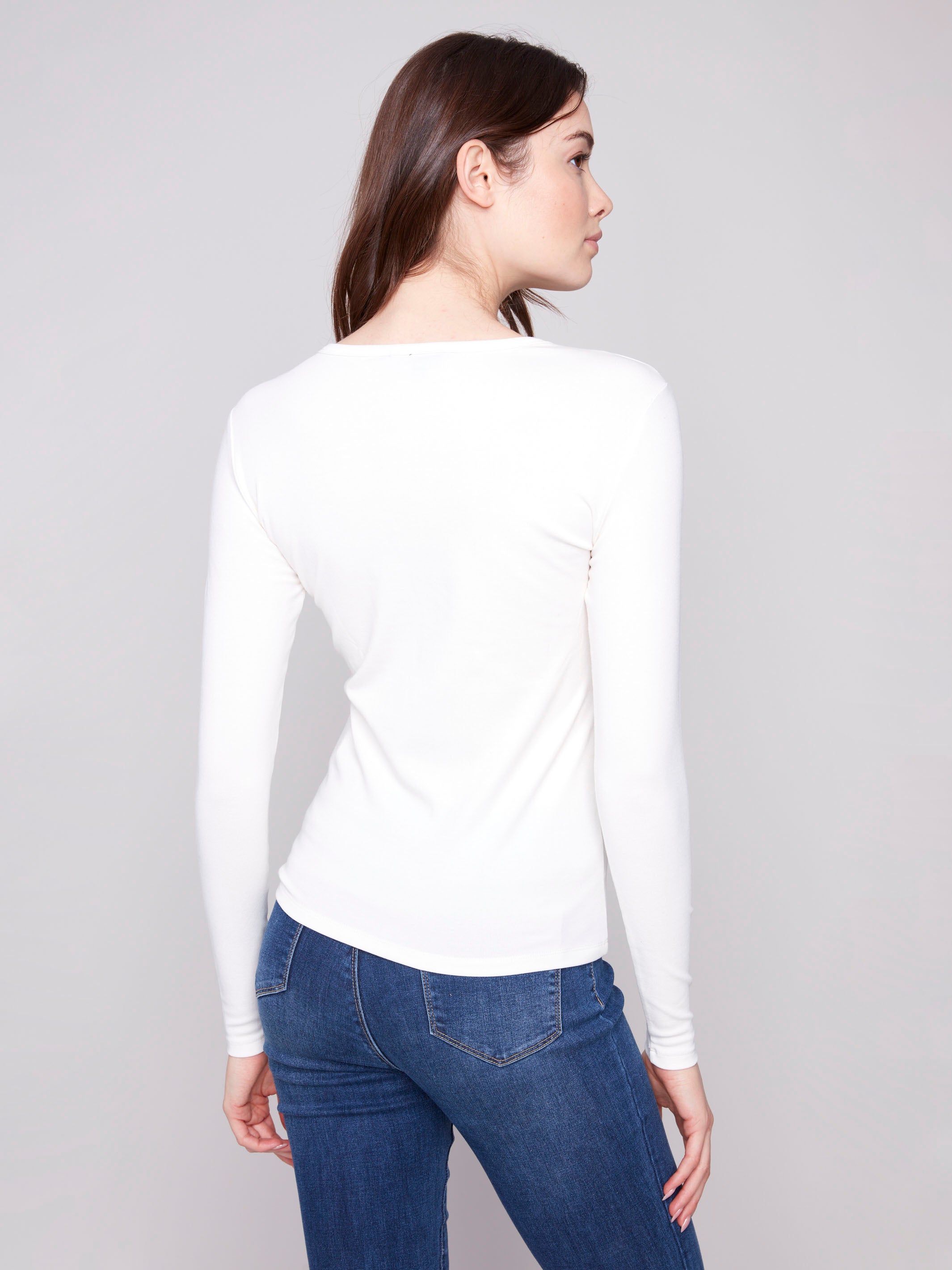 Ecru knit top designed with long sleeves for added warmth and style in cooler weather by Charlie B.