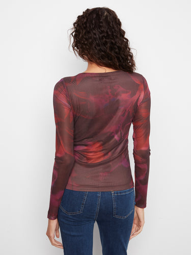 Adorned with a vibrant floral pattern, this top brings a touch of nature-inspired charm to your wardrobe. By Charlie B.