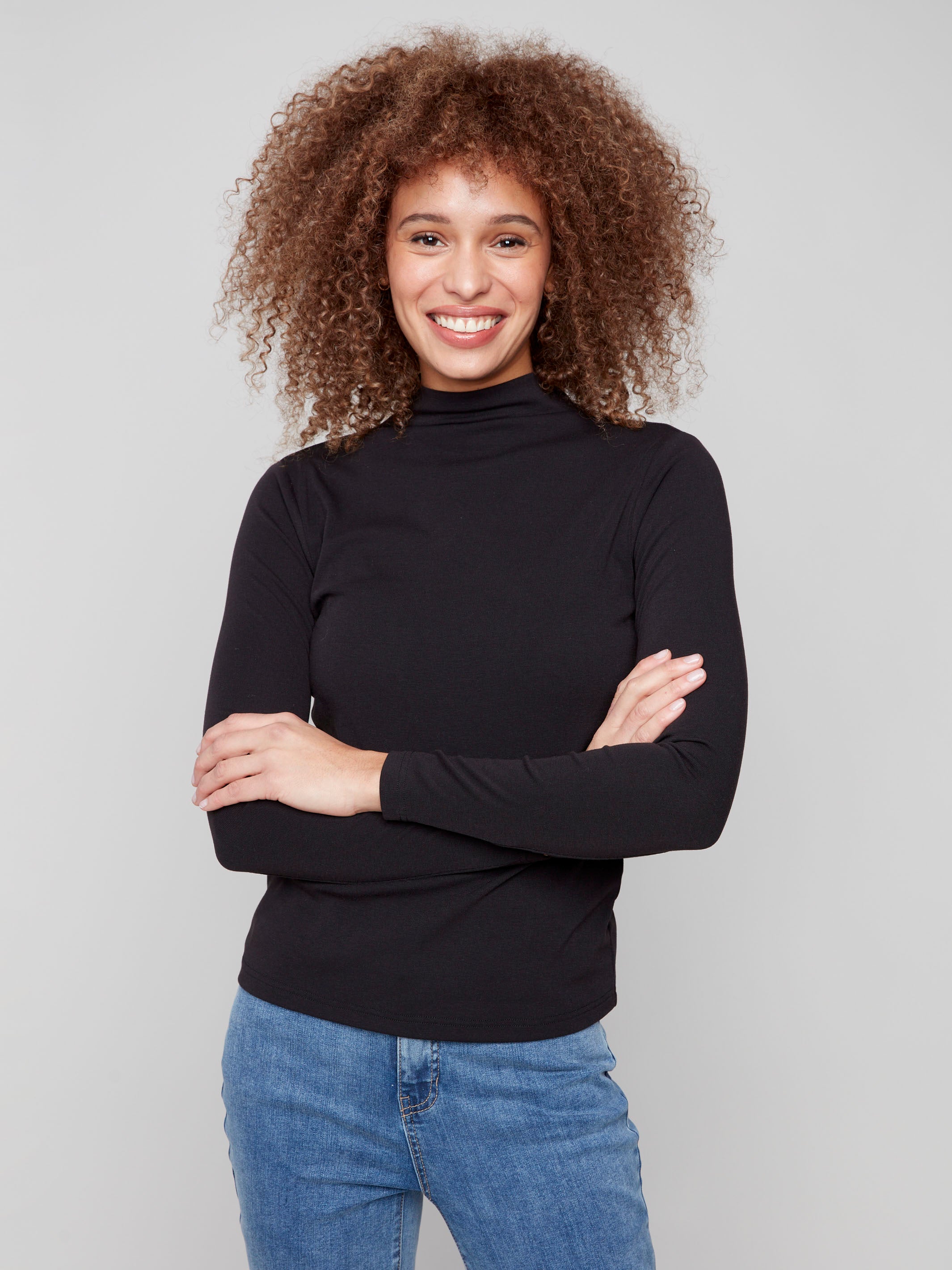 Black top with slim fit and fine ribbed texture, perfect for layering by Charlie B.