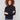 Black top with slim fit and fine ribbed texture, perfect for layering by Charlie B.