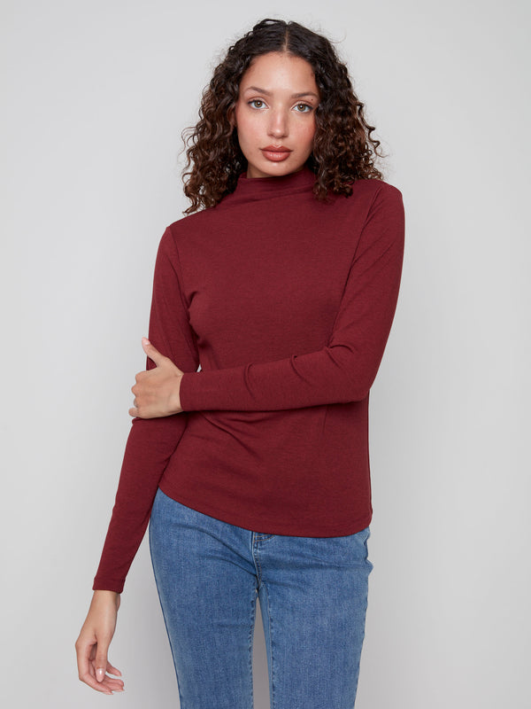 Comfortable long sleeves enhance the sleek look of this cabernet top by Charlie B.