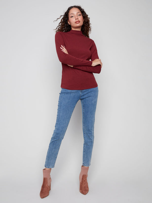 This versatile cabernet top pairs effortlessly with jeans or skirts for any occasion by Charlie B.