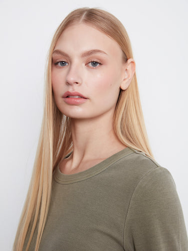 Close-up of an olive shirt crafted from a stretch cotton-tencel blend, ensuring flexibility and ease. By Charlie B.