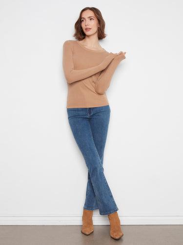 Stylish and form-fitting top featuring long sleeves and ribbed texture, perfect for layering or wearing alone. By Charlie B.