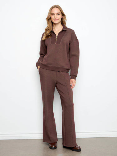 The ensemble showcases ribbed cuffs and hem, adding a touch of detail to the relaxed fit. Designed by Charlie B.