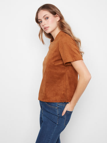 This coffee-toned top showcases a subtle side slit, adding elegance to its simple silhouette by Charlie B.