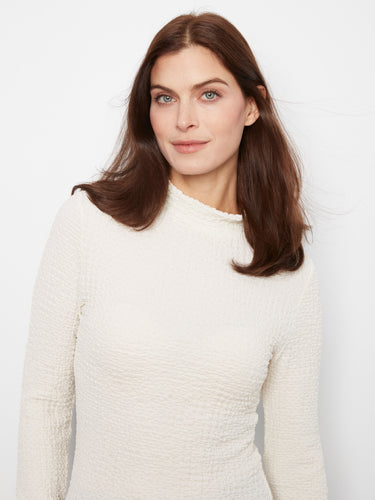 This stylish garment showcases lettuce-edge trim, adding a playful touch to your outfit. Made with care by Charlie B.