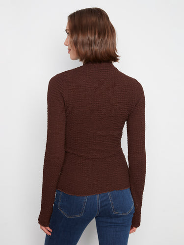 Featuring both style and comfort, the mock neck design complements the bubble knit texture seamlessly by Charlie B.