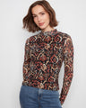 This top features a mock neckline in a vibrant pattern, offering a chic and stylish look for any occasion. By Charlie B.