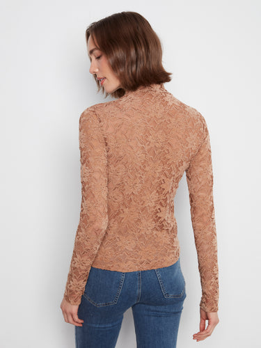 A body lined interior ensures comfort while the intricate lace pattern offers timeless elegance in this piece. By Charlie B.
